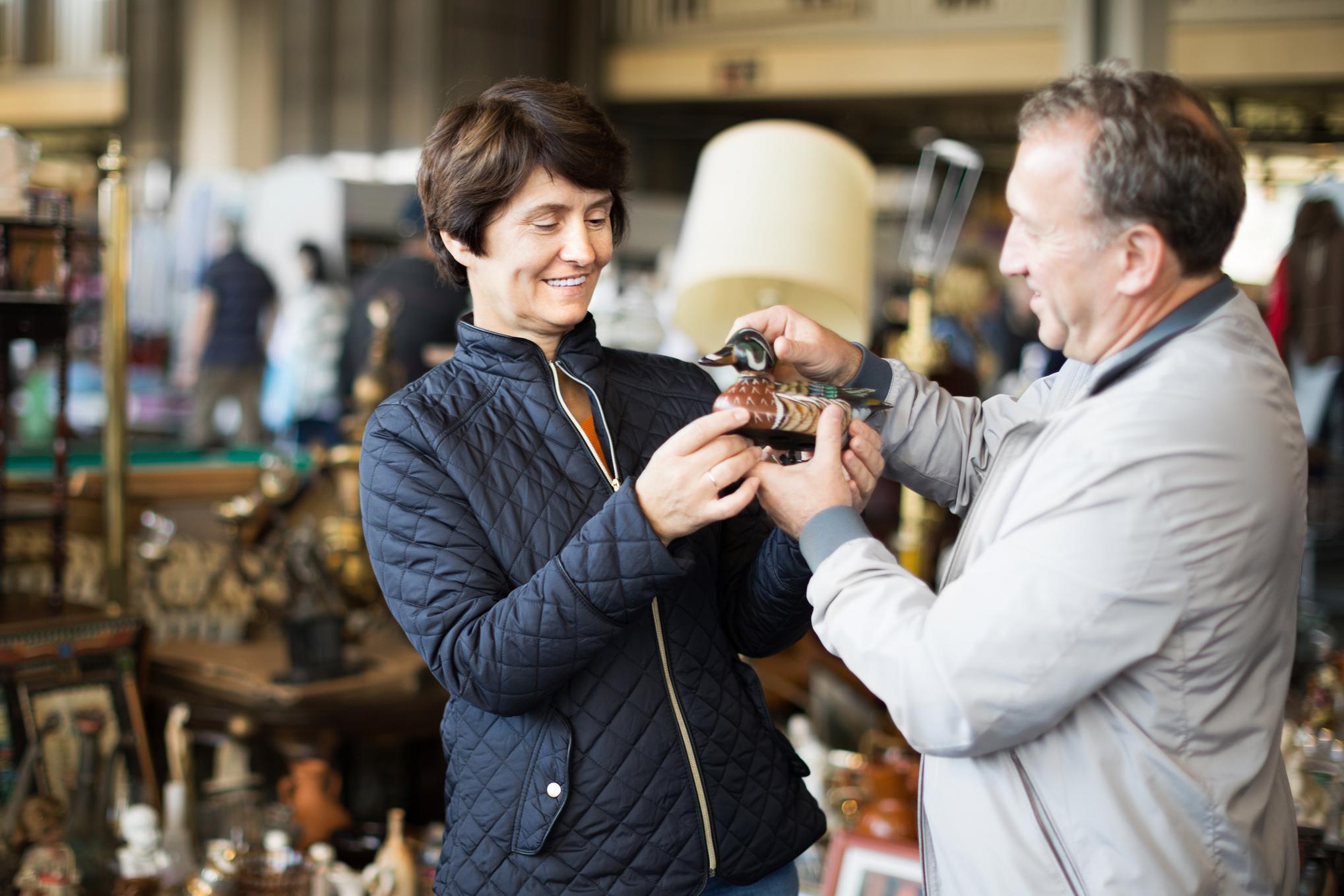Mature couple buying antique things at the fleamarket